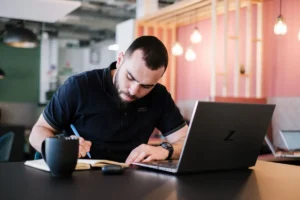 Male Student Taking Notes